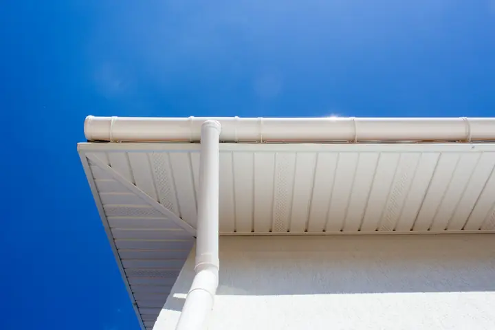 Clean white UPVC soffit, fascia and gutter against a blue sky